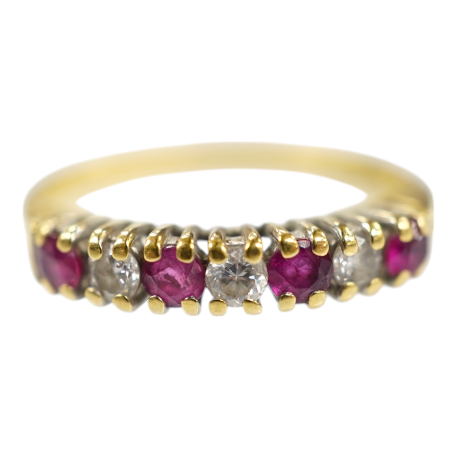 A modern 18ct gold, four stone ruby and three stone diamond set half hoop ring, size P, gross weight 2.8 grams. Condition - fair